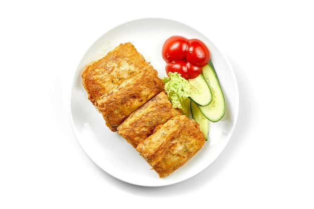 Crepes with stuffing and salad in a white plate Closeup selective focus White background