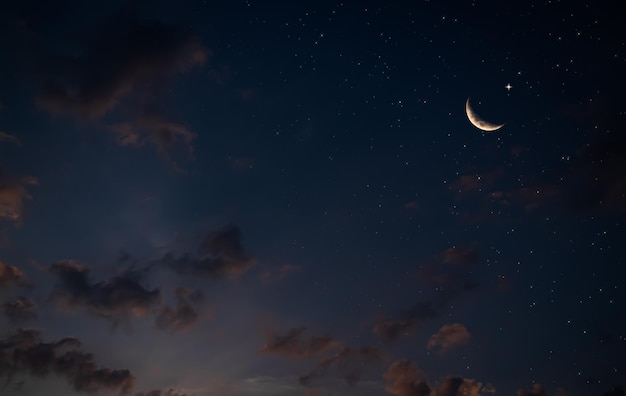 A crescent moon and stars in the sky