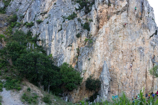 Crimea Ukraine July 25 2021 A group of children are engaged in rock climbing as a sport on the rocks in the Crimean mountains