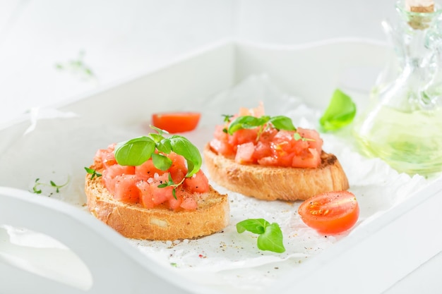 Crisp bruschetta with basil and tomato for breakfast