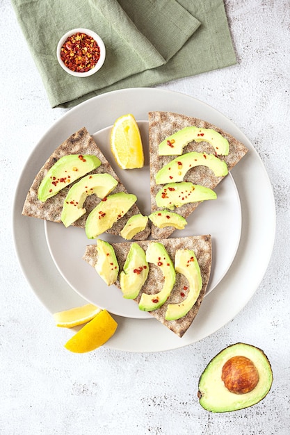 Crisp rye bread sandwiches with avocado slices