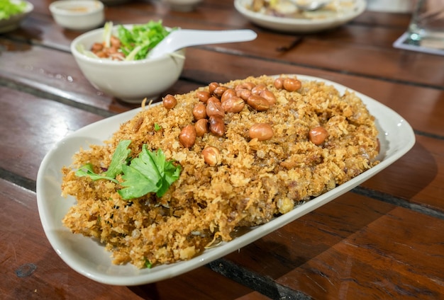 Crispy catfish salad with green mango sauce spicy