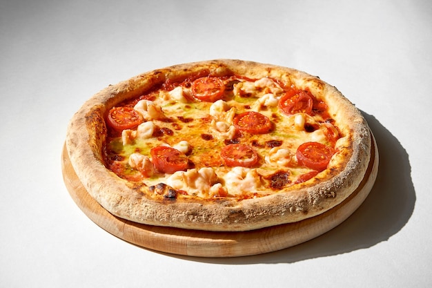 Crispy chicken and tomato pizza on a gray background