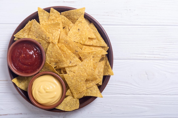 Crispy chips nachos with tomato and cheese sauce Traditional mexican food