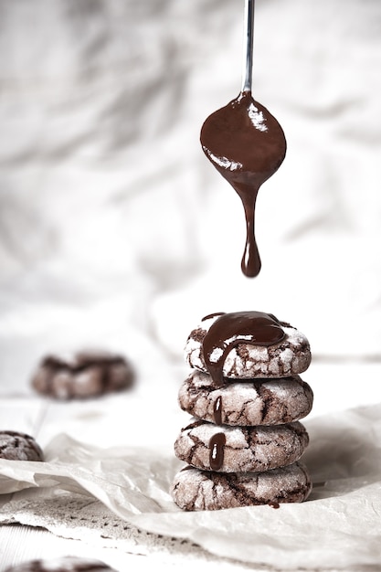 Crispy chocolate chip cookies on wooden background in vintage style.