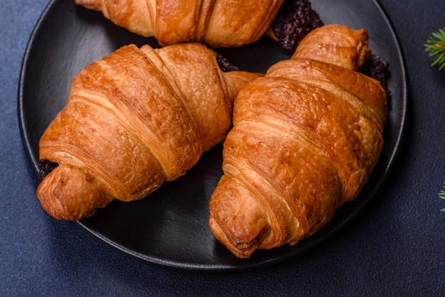 Crispy chocolate croissant with Christmas decorations on wooden cutting board