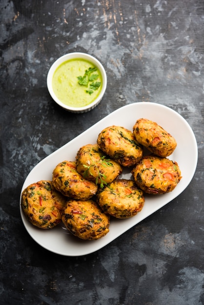 Crispy Corn Tikki, pakora or pakoda or pattice also known as cutlet. served with green chutney. Selective focus