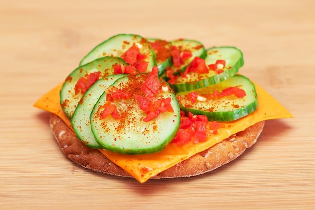 Crispy cracker sandwich with fresh cucumber cheese and paprika