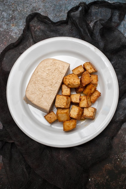 Crispy deep stir fried tofu cubes on small dish