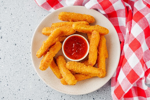 crispy fresh chicken strips on a gray stone background