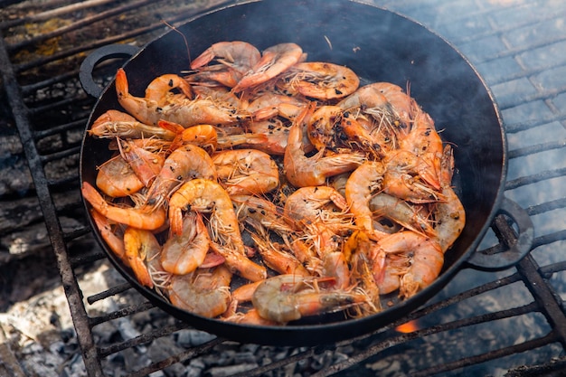 crispy fresh shrimp cooked on a frying pan in the wild