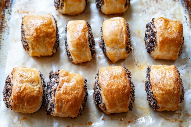 Crispy freshly baked cookies with poppy seeds on a baking tray