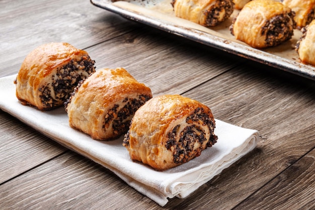 Crispy freshly baked cookies with poppy seeds on a wooden background