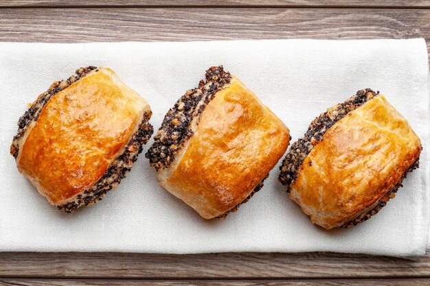 Crispy freshly baked cookies with poppy seeds on a wooden background