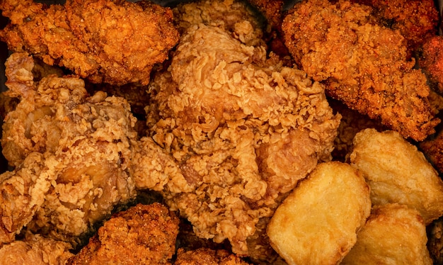 Crispy fried chicken and nuggests. Fast food background. Spicy testy.