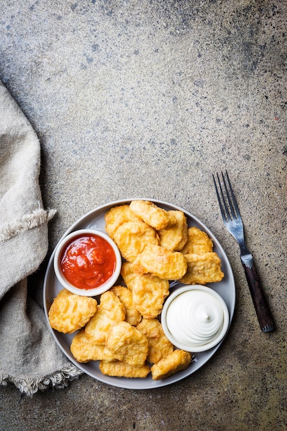 Crispy fried chicken nuggets with tomato sauce