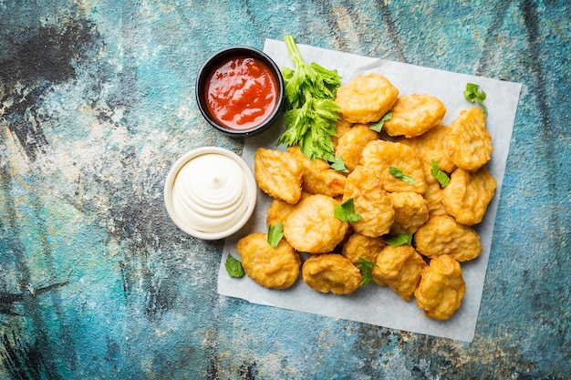 Crispy fried chicken nuggets with tomato sauce