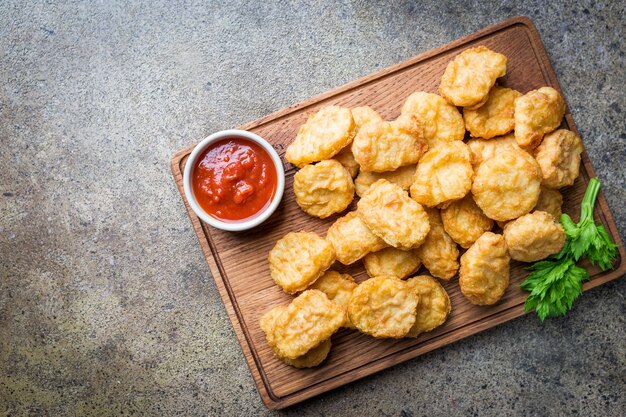 Crispy fried chicken nuggets with tomato sauce