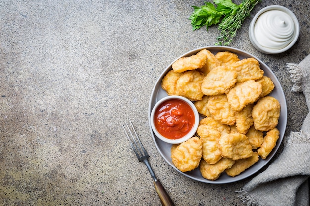 Crispy fried chicken nuggets with tomato sauce