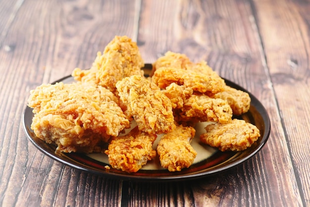 Crispy fried chicken wings on a plate top view