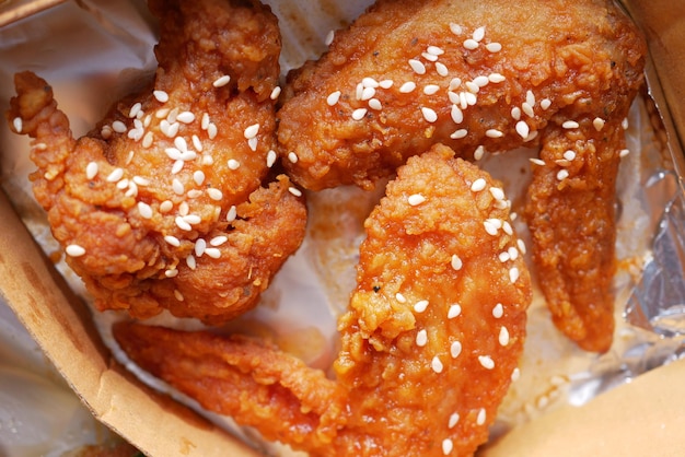 Crispy fried chicken wings on a plate top view