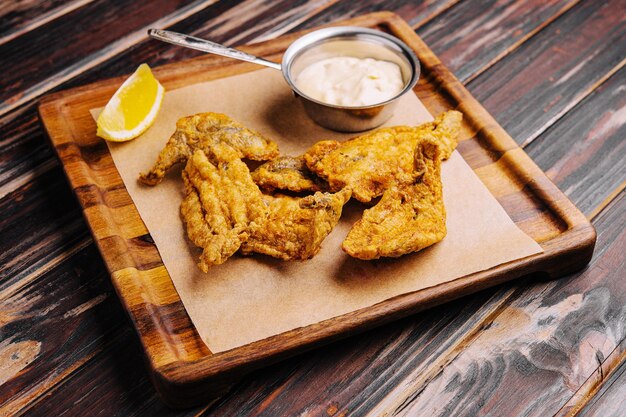 Crispy fried fish on a wooden rustic board