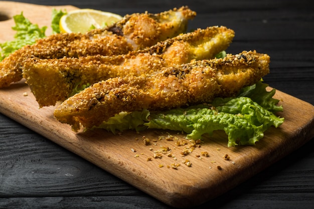 Crispy fried fish on a wooden rustic board