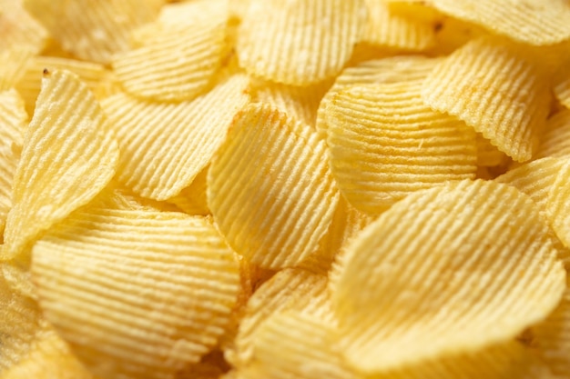 Crispy golden potato chips snack texture background