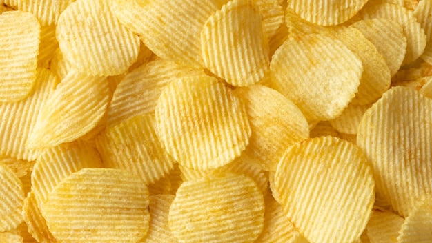 Crispy golden potato chips snack texture background