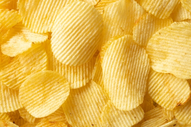 Crispy golden potato chips snack texture background