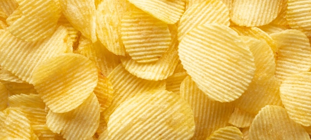 Crispy golden potato chips snack texture background