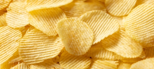 Crispy golden potato chips snack texture background