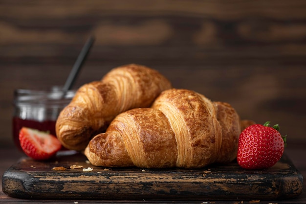 Crispy homemade croissants on a wooden board