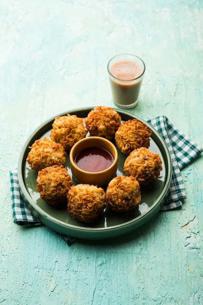 Crispy Noodles Pakora or pakoda is a popular indo-chinese street food served with ketchup