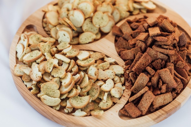 Crispy potato chips in a wicker bowl on old kitchen table