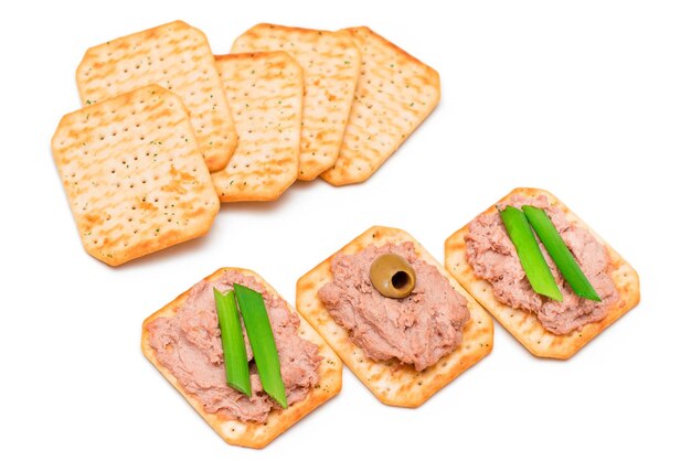 Crispy salted crackers with liver pate green onions and olives