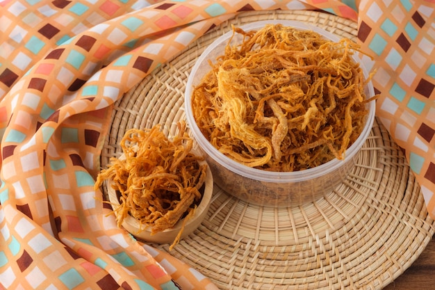 Crispy Shredded Pork on wood tray.