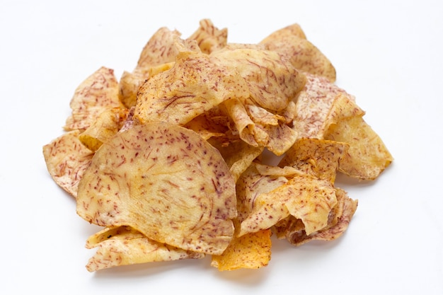 Crispy taro chips on white background.