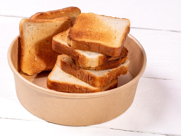 Crispy toasted white bread slices arranged on clean white table