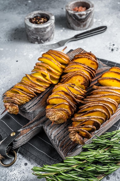 Crispy Tornado or twist potatoes chips on wooden board Gray background Top view