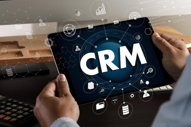 CRM Business Customer CRM Management Analysis Service Concept Business team hands at work with financial reports and a laptopxA