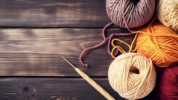 Crochet and knitting hobby Colorful balls of yarn knitting needles on table with copy space flat lay and wood background