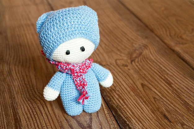 Crochet soft toy on a wooden background