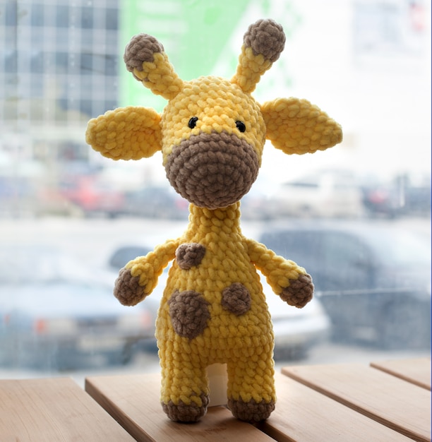 Crocheted amigurumi yellow giraffe. Knitted handmade toy.