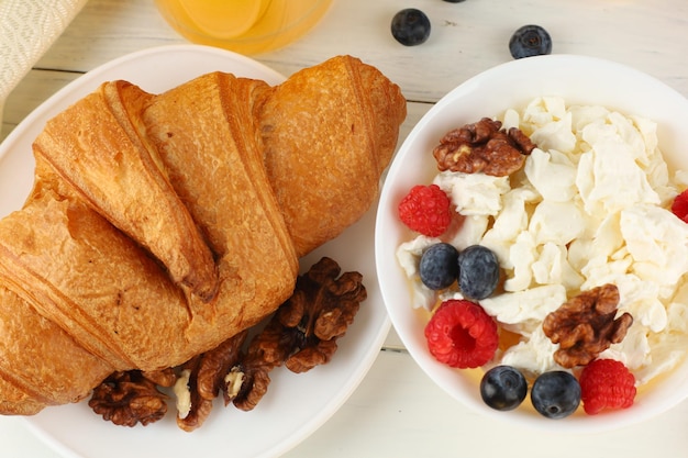 Croissant breakfast with cheese berries and nuts Hearty and healthy food