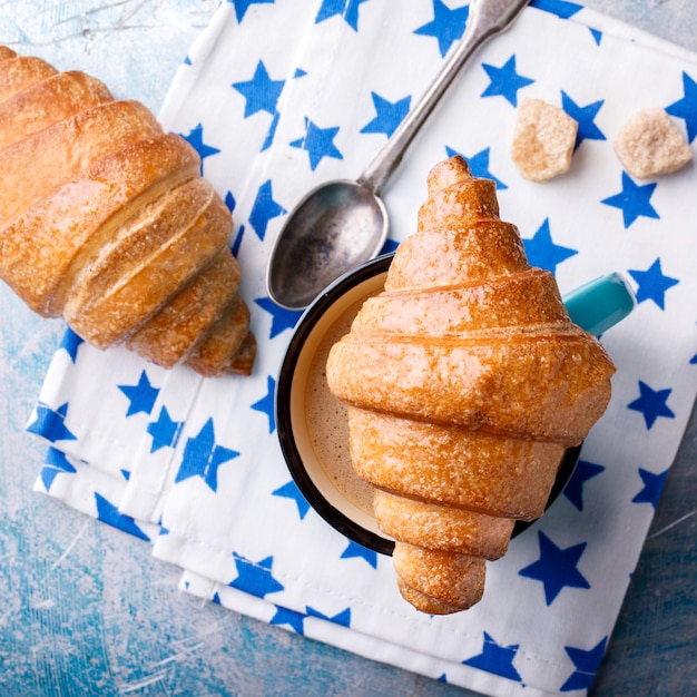 Croissant and Coffee with milk. Breakfast Fresh Baking.