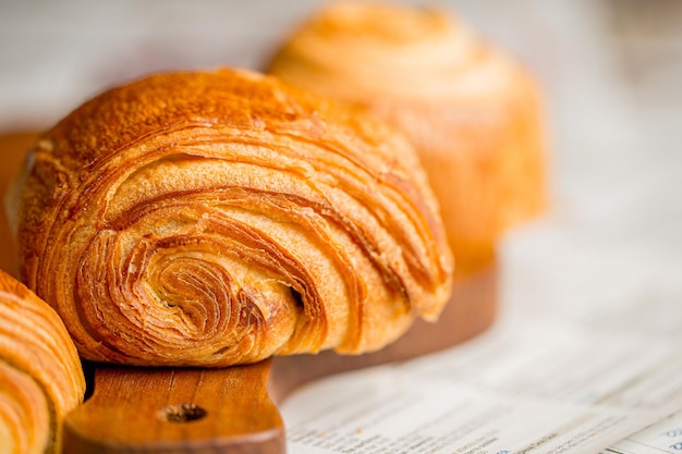 Croissant macro. French croissant with waves. Air baking. Croissant for puff pastry advertising.