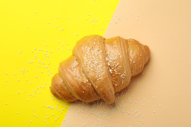 Croissant and sesame on two tone, top view