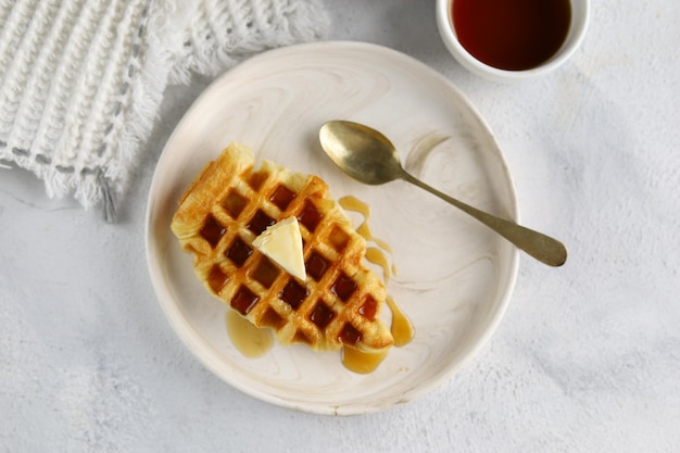 Croissant Waffle or croffle in white plate with butter and honey