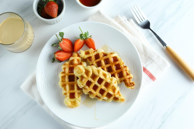 Croissant Waffle or croffle in white plate with strawberry